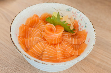 Salmon Don : Japanese rice with a lot of salmon in  Japanese ceramic bowl put on the table