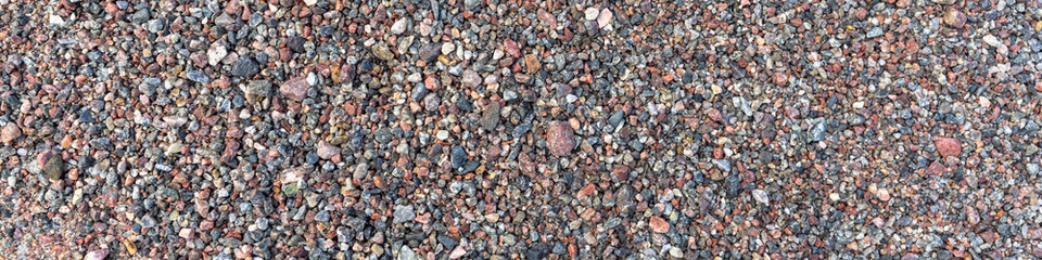 Sea pebble texture. Small multicolored pebble-stones. Close up beach stones surface.