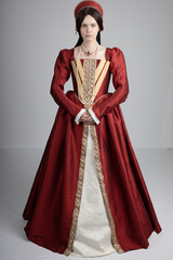 Dark-haired Tudor woman in red dress - obrazy, fototapety, plakaty