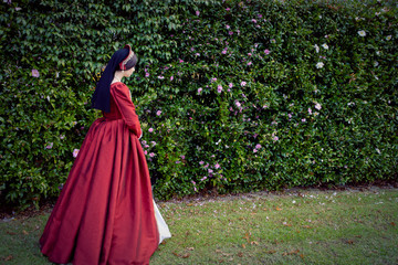 Dark-haired Tudor woman in red dress