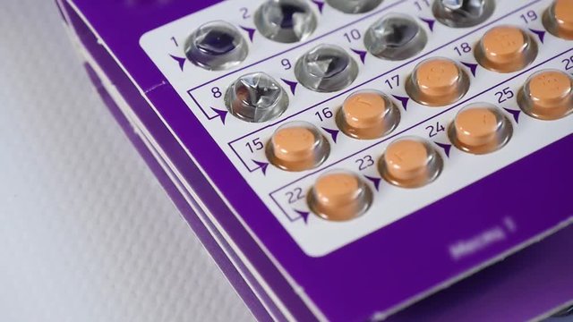 Blister with pills close-up. The concept of family planning, oral contraception. Health and medicine.