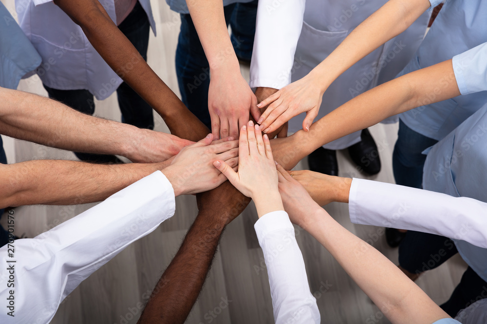 Wall mural Elevated View Of Doctors Stacking Hands