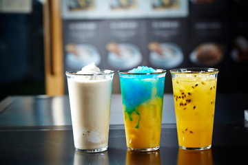 Vanilla shake, blue hawaii, passion fruit drink and orange juice in pitcher 