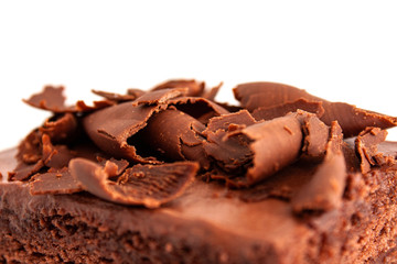 A piece of chocolate cake with shavings isolated background