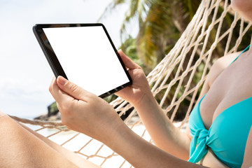 Woman Lying On Hammock Holding Digital Tablet