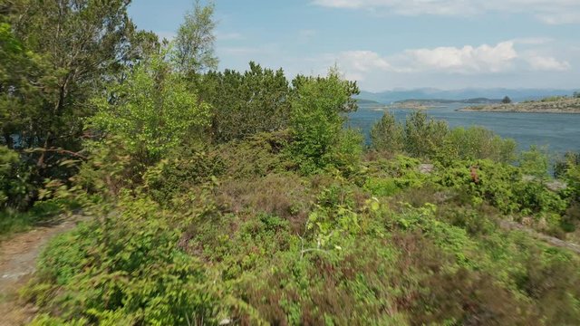 Long Dramatic Cinematic Fast Pull Back Aerial of Scandinavian Fjord Nature on Sunny Spring Day With North Sea Rocky Coast and Peninsula 4k