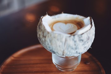 Close up coffee latte art in coconut.