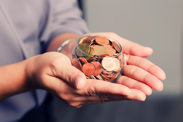 Fototapeta premium coins in hands. saving money concept