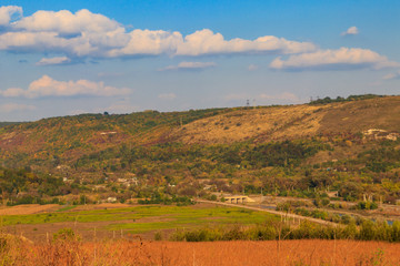 Picturesque autumn scenery with blue sky and colorful autumn trees on mountain hills