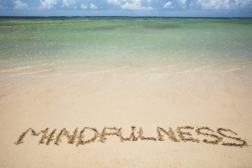 Fototapeta na wymiar Mindfulness Written Text On Sand At Beach