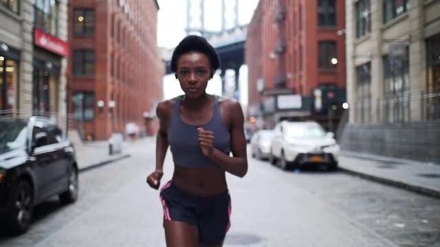  Woman urban runner training in New york city at sunrise. Concept about sport and people