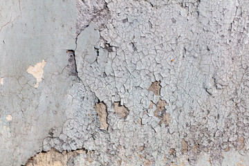 White wall with cracked plaster as abstract background