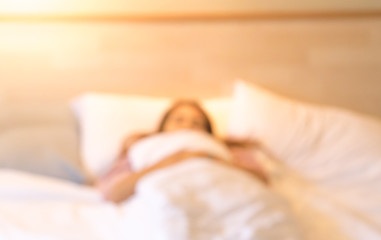 Fototapeta na wymiar The blurry asian woman sleeping on the bed.