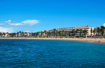 Naklejka na ściany i meble View of Playa del Camison beach with turquoise water and yellow sand in Las Americas, Tenerife,Canary Islands,Spain.Summer vacation or travel concept.
