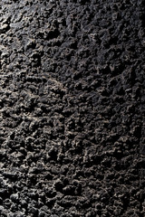 Black wall of sand and concrete as an abstract background