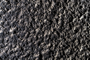 Black wall of sand and concrete as an abstract background