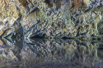 A colorful rock wall Inside Rydal cave in the Lake District, UK, above Lake Grasmere. 