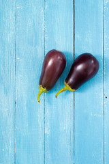 two eggplants on blue wood table