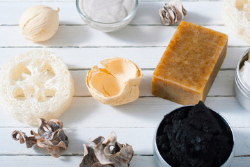 organic skin care butters from, shea, macadamia nut, coffee, mango, and cosmetic clay, mud on white wooden