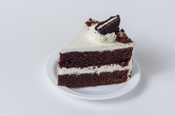 A piece of cake with chocolate chip cookies on a white background