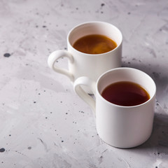Masala tea in white minimalist cups on a gray table