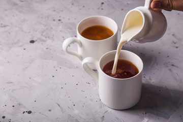 Masala tea in white minimalist cups on a gray table