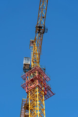 Fototapeta na wymiar yellow crane and blue sky on building site