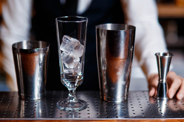barman at work. A young bartender works with a shaker. Prepares delicious alcoholic cocktails