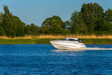 Fototapeta na wymiar Modern motorboat in a river, summer, Europe