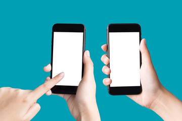 two hands holding and playing smart phones on green background with clipping path