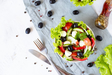Appetizing greek salad in a plate on a served table