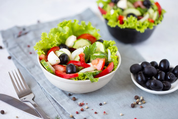 Appetizing greek salad in a plate on a served table