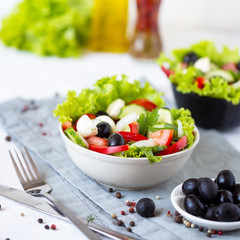 Appetizing greek salad in a plate on a served table