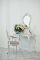 elegant table with flowers and mirror