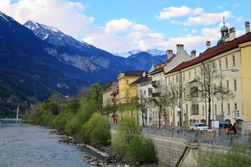 Beautiful building by the river, mountain and the blue sky in Innsbruck, Austria. Morning in spring time.