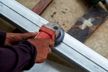 Hand Electric wheel grinding on steel