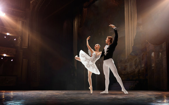 Ballet. Classical ballet performed by a couple of ballet dancers on the stage of the opera house.