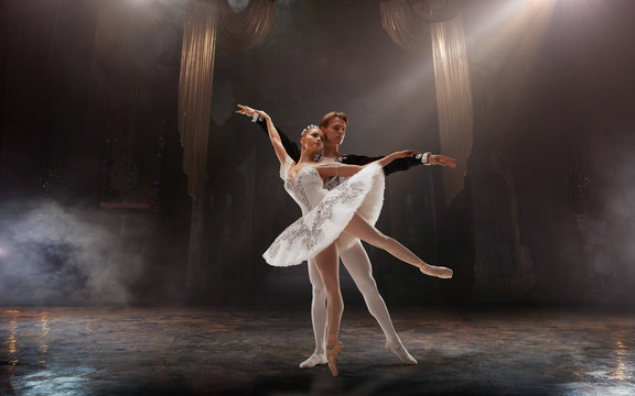 Ballet. Classical ballet performed by a couple of ballet dancers on the stage of the opera house.