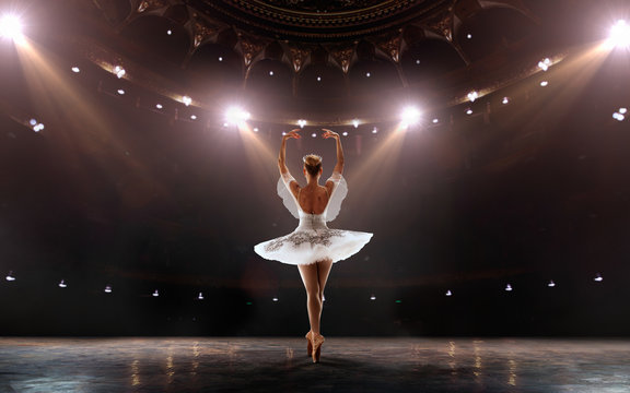 Ballet. Classical ballet performed by a couple of ballet dancers on the stage of the opera house.