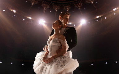 Ballet. Classical ballet performed by a couple of ballet dancers on the stage of the opera house.