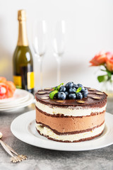 Belgian Chocolate Layered Gateau. Layers of moist choco sponge, vanilla cream and indulgent dark chocolate mousse glazed with rich dark chocolate sauce and hand decorated with fresh blueberries