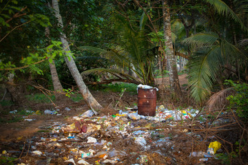 pile of waste  and rusted oil barrel in the indian nature
