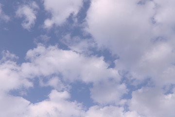 White clouds against the blue sky. Background, cropped shot, horizontal, place for text. Nature concept.