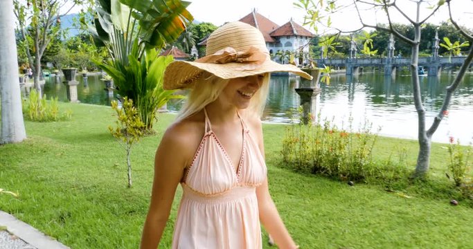 Beautiful caucasian girl visiting the water palace in Bali