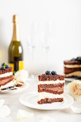 Belgian Chocolate Layered Gateau. Layers of moist choco sponge, vanilla cream and indulgent dark chocolate mousse glazed with rich dark chocolate sauce and hand decorated with fresh blueberries