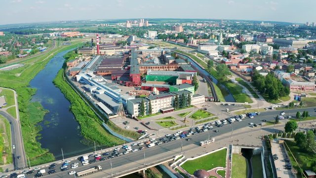 Aerial view of Tula city center or downtown with bridge over river Upa, modern and historic buildings, factories and car traffic in sunny summer day