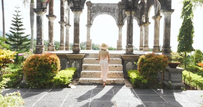 Beautiful caucasian girl visiting the water palace in Bali