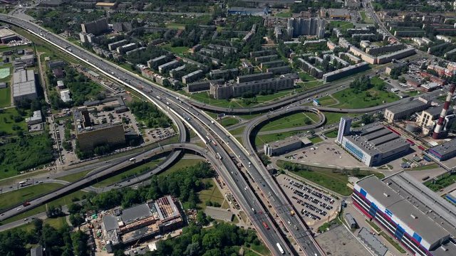 AERIAL. Amazing topview of two-level road junction in Russia. Day traffic of expressways. Saint - Petersburg