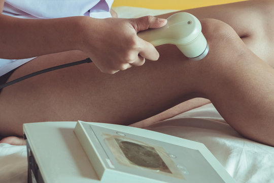 Physicaltherapist using ultrasound probe on my yourself's knee for release pain.