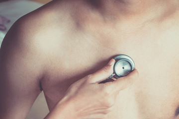 Fototapeta premium Doctor examining patient with stethoscope in hospital. Medical examination, stethoscope, medicine and therapy.